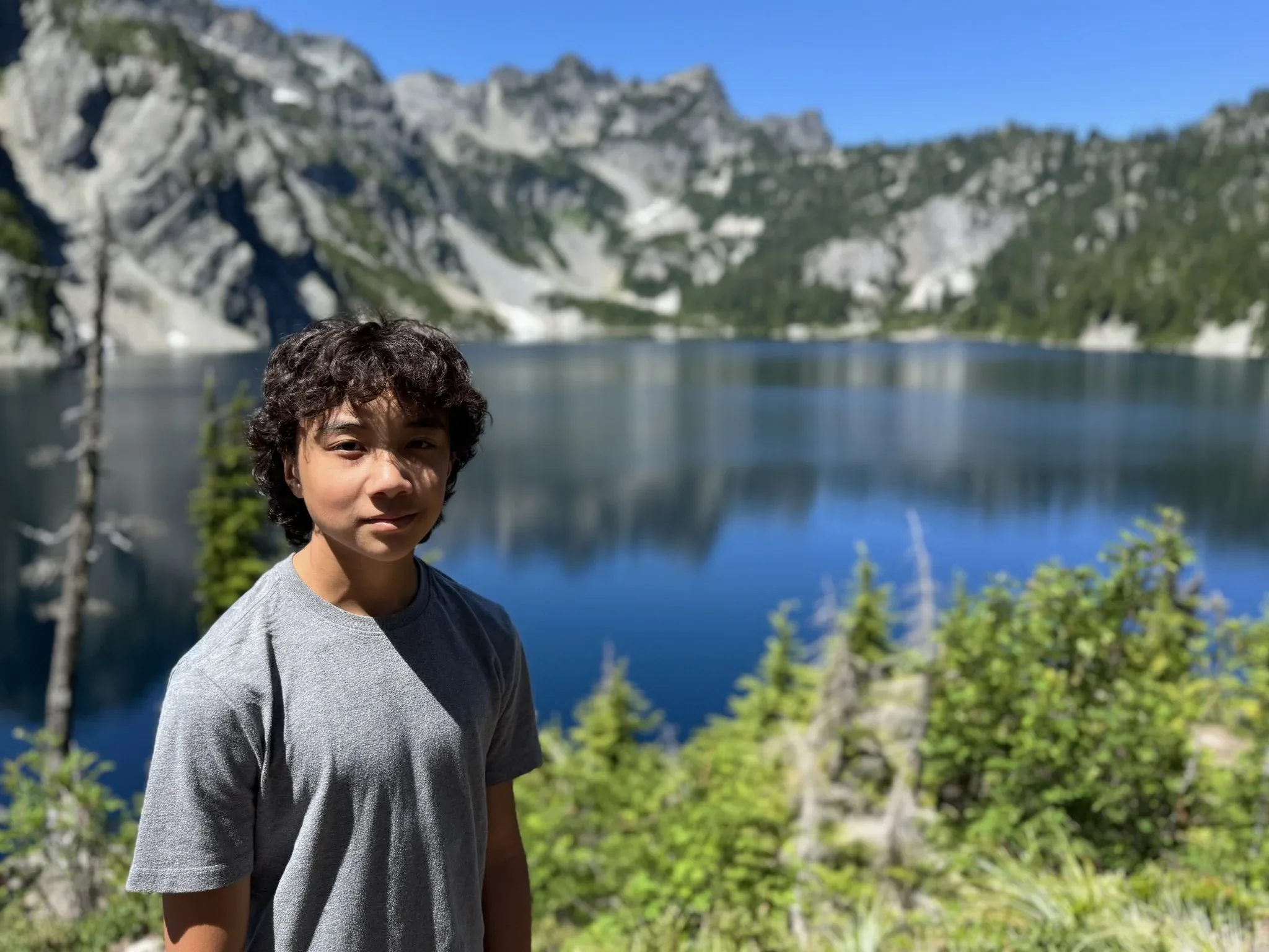My grandson with the out of focus Snow Lake in the background.