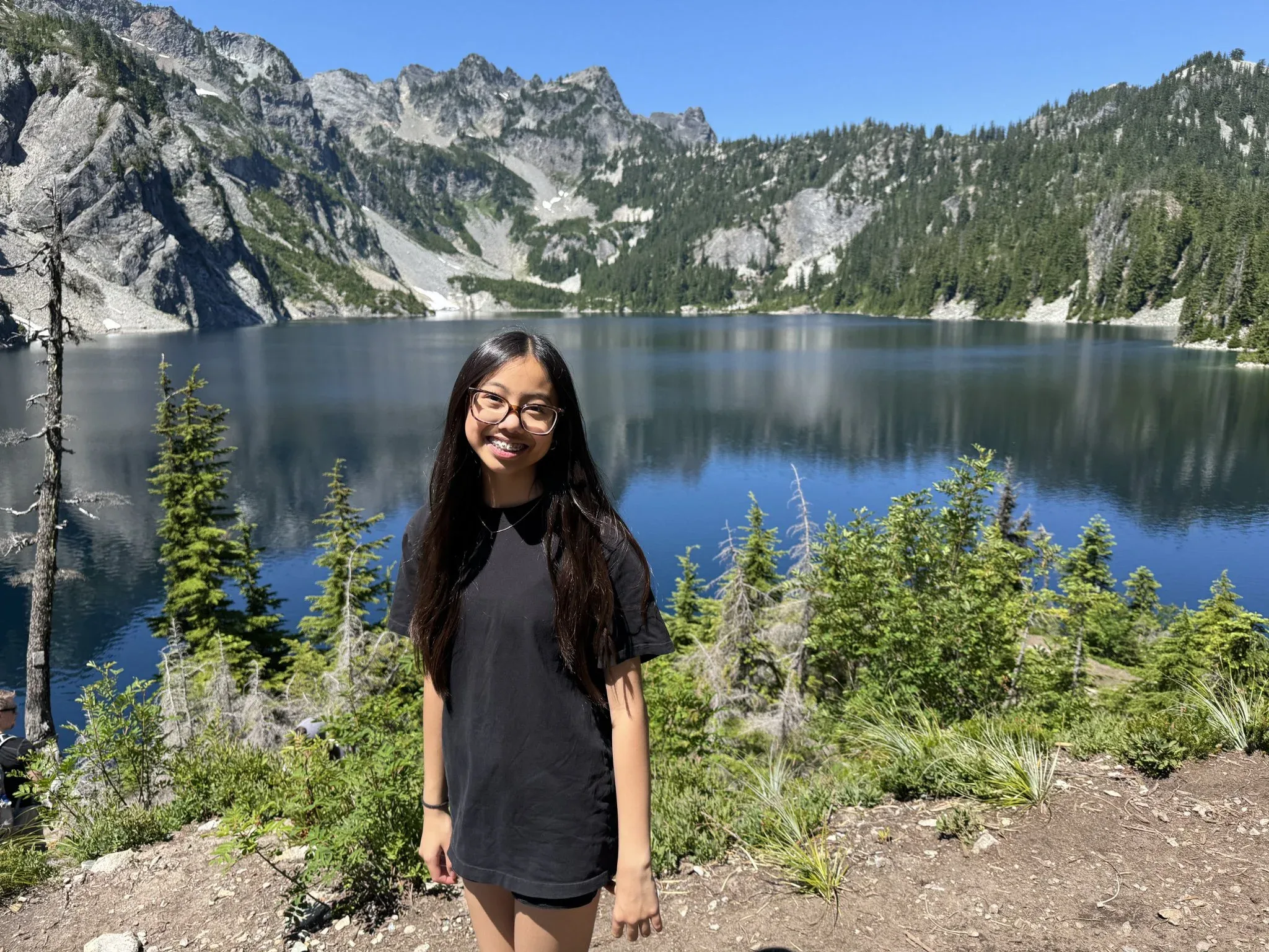 My granddaughter with the slightly out of focus Snow Lake in the background.